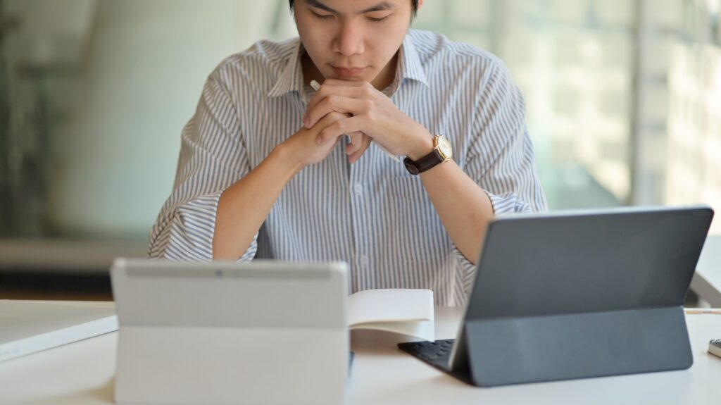Male teachers preparing to teach online with digital tablet.